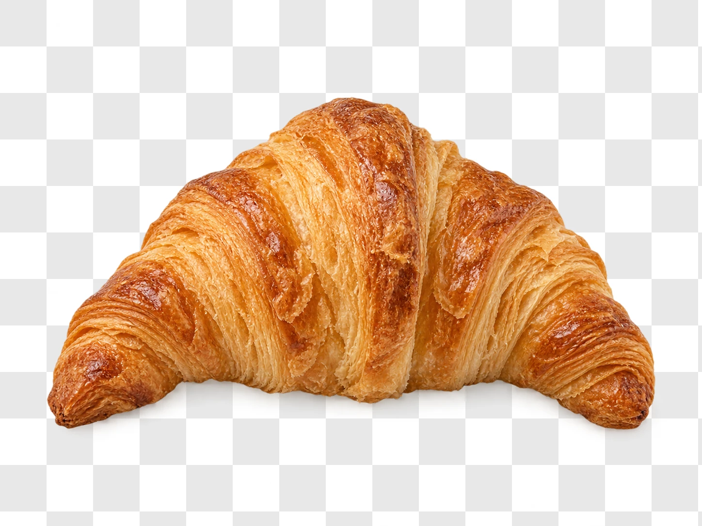 A golden flaky croissant cut out cleanly on a transparency checkerboard, a finished cutout ready to use
