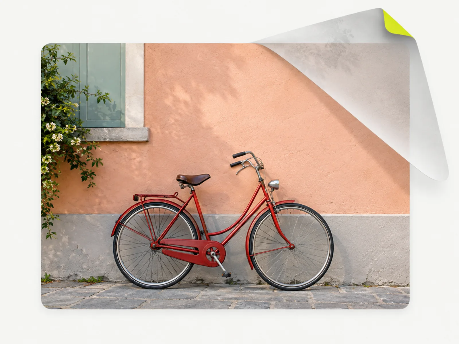 A translucent watermark layer being peeled off a photo of a red bicycle, revealing the untouched image beneath