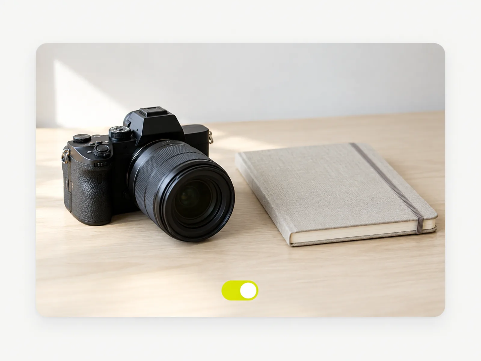 A camera and notebook on a desk with an ON toggle switch indicating the rights confirmation is enabled